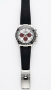 Roleex Cosmograph Daytona chronograph white-and-red dial paired with a black rubber strap